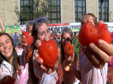 Young people holding tomatoes close up 