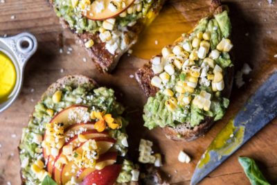 Open faced toasts with avocado, corn and apples